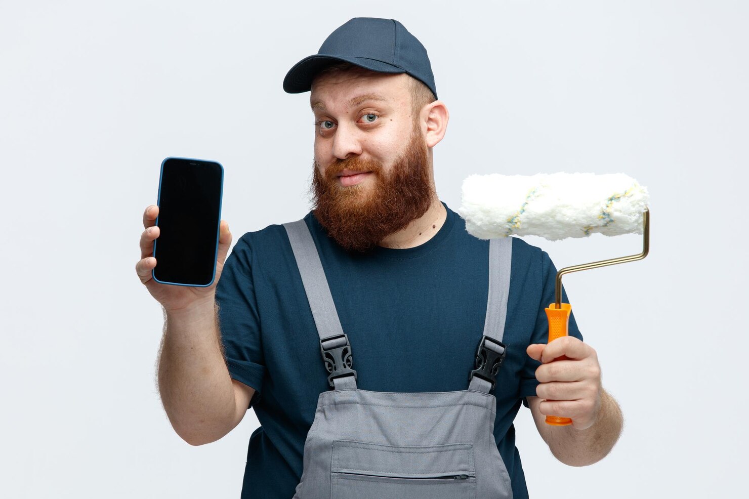 pleased young male construction worker wearing cap uniform holding paint roller looking camera showing mobile phone camera isolated white background 141793 131891